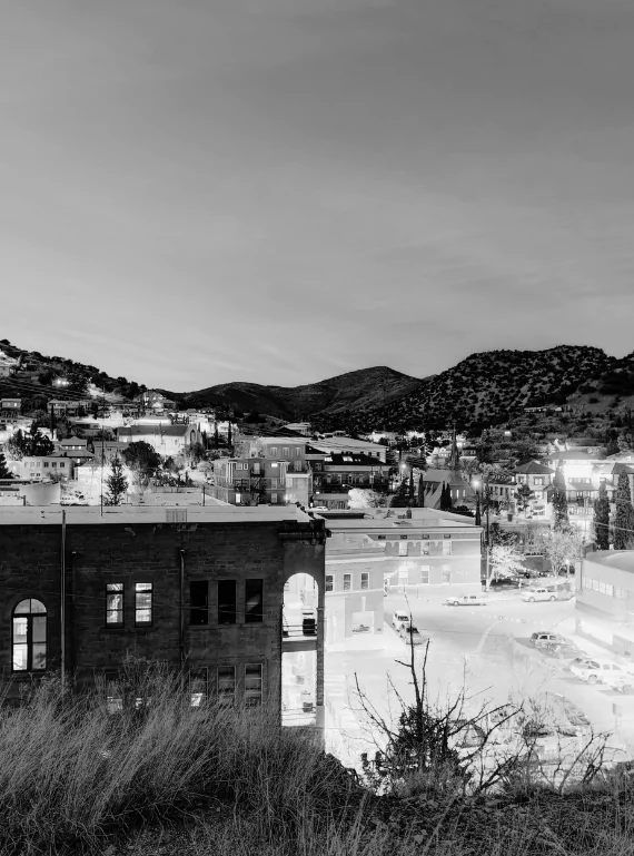 Old Bisbee at dusk with hillside houses above the brick downtown