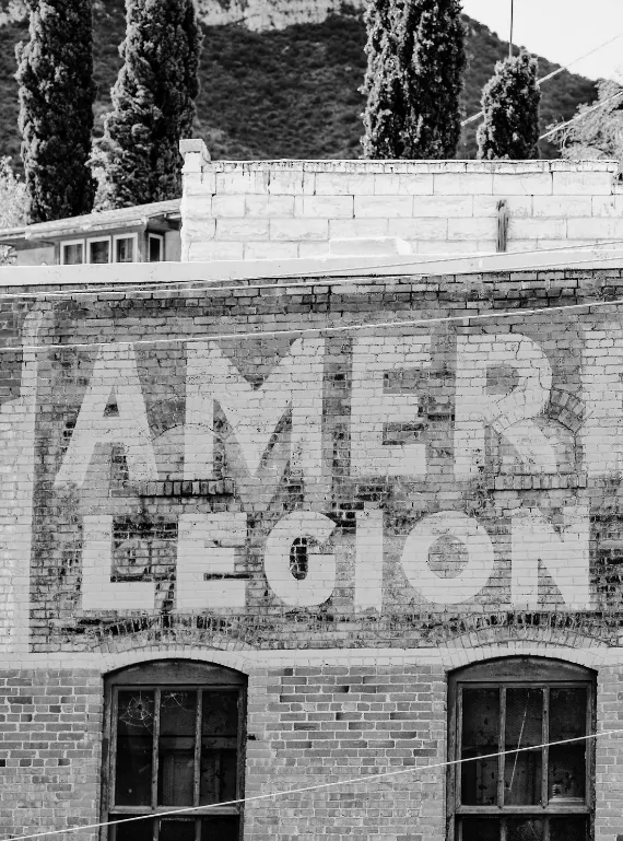 Faded American Legion ghost sign on a brick building in Bisbee