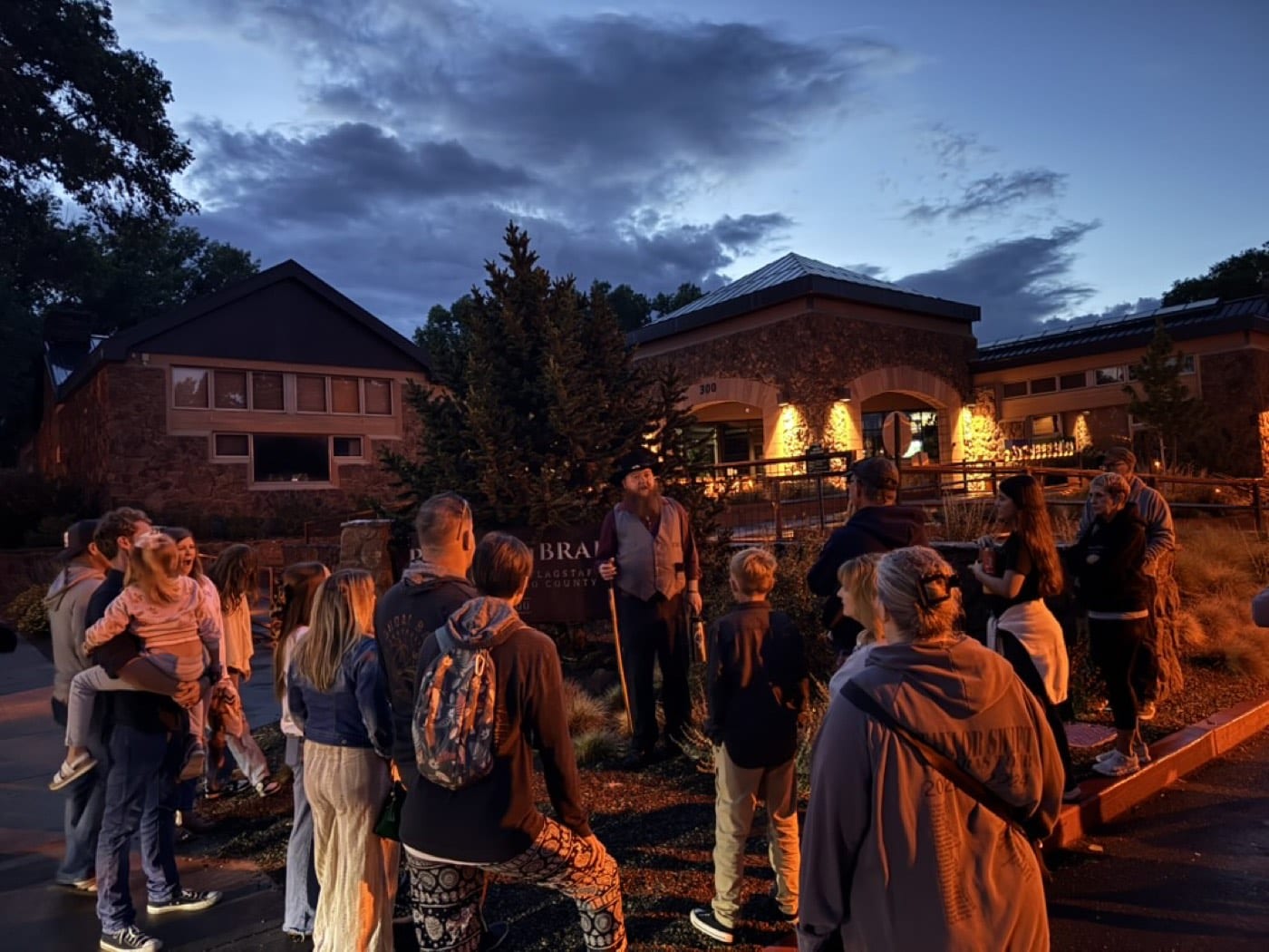 Kids and parents alike lean in as the lantern-lit stories start outside the library on a cool Flagstaff night.