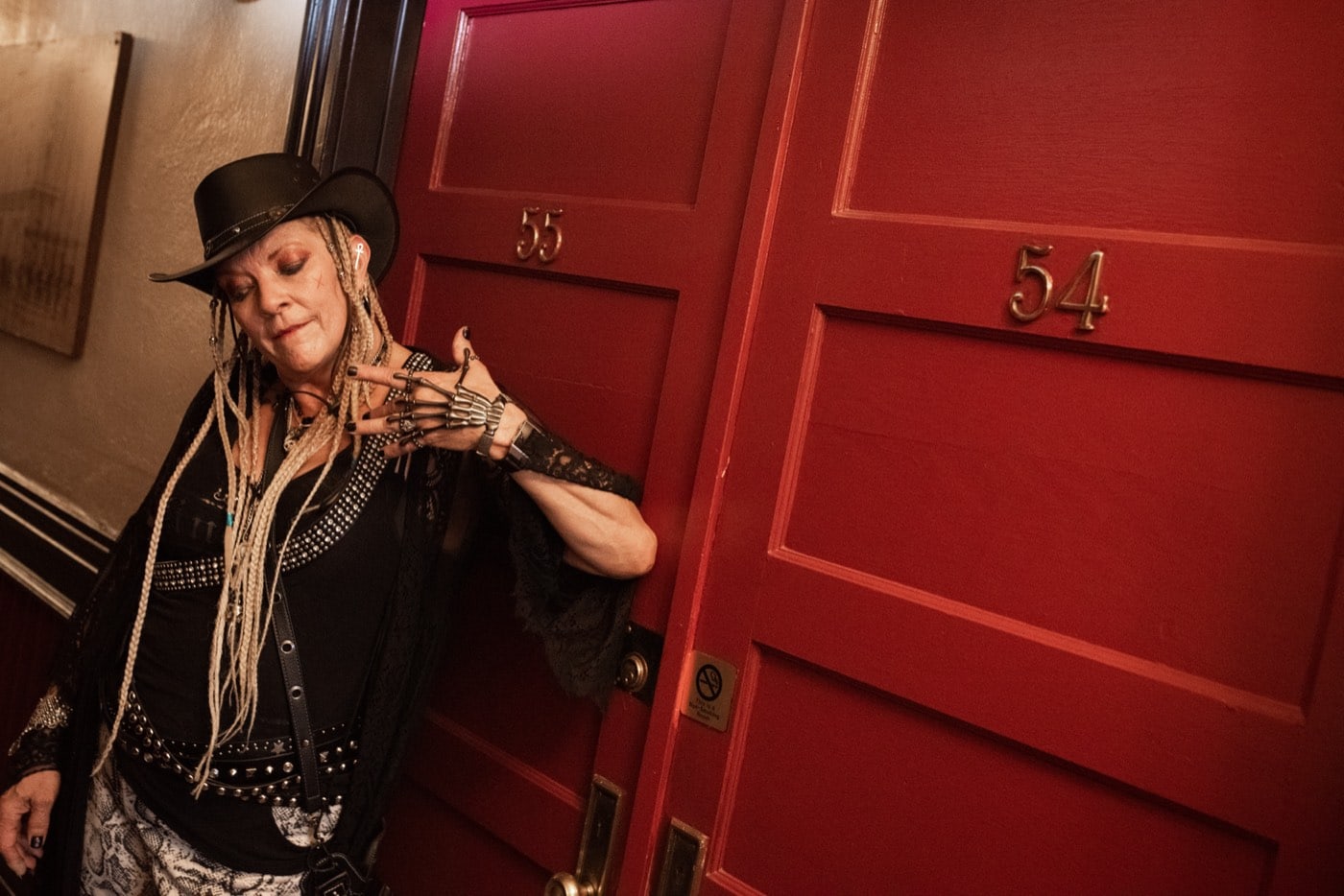 A Freaky Foot Tours guide flashes her skeleton glove outside rooms 54 and 55 at the Hotel Monte Vista, where a phantom bellboy still knocks for guests who never answer.