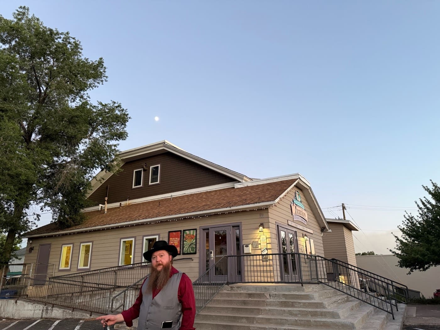 Our guide pauses outside the Theatrikos playhouse as the moon rises over a summer evening tour.