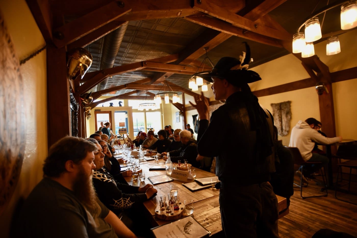 Lit by mason-jar lanterns, a Freaky Foot Tours storyteller in a feathered hat works the tables of a Flagstaff mead hall during an adults-only haunted pub crawl.