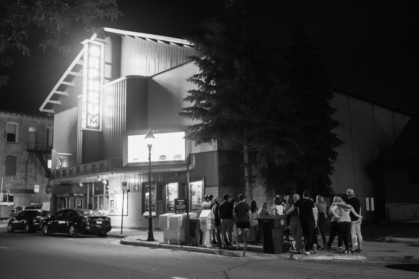 A night tour group beneath the neon marquee of the Orpheum Theater in downtown Flagstaff