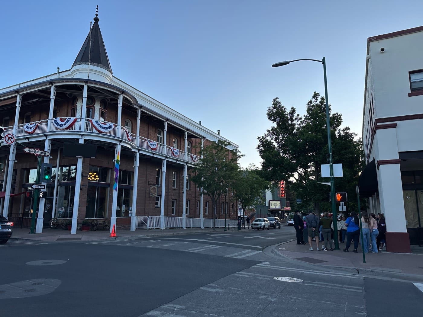 Evening settles over the Weatherford Hotel's cupola and double balconies at Leroux and Aspen, the porch where author Zane Grey once wrote, while the Orpheum's sign glows down the block.