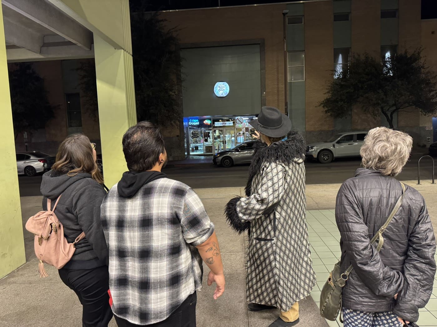 A guided tour group outside the Pioneer Hotel on Stone Avenue