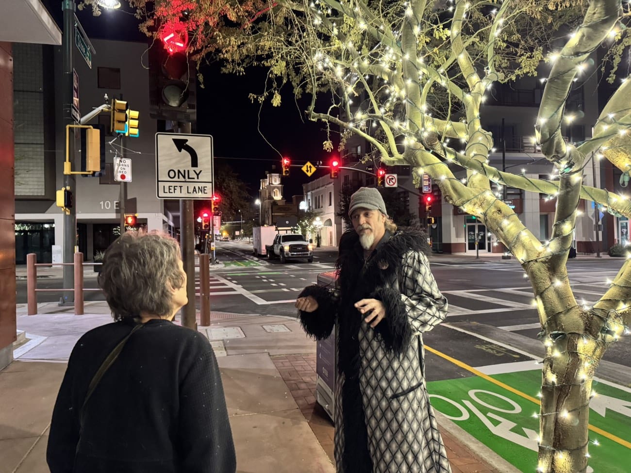 A Freaky Foot Tours guide telling stories under the Congress Street lights at night