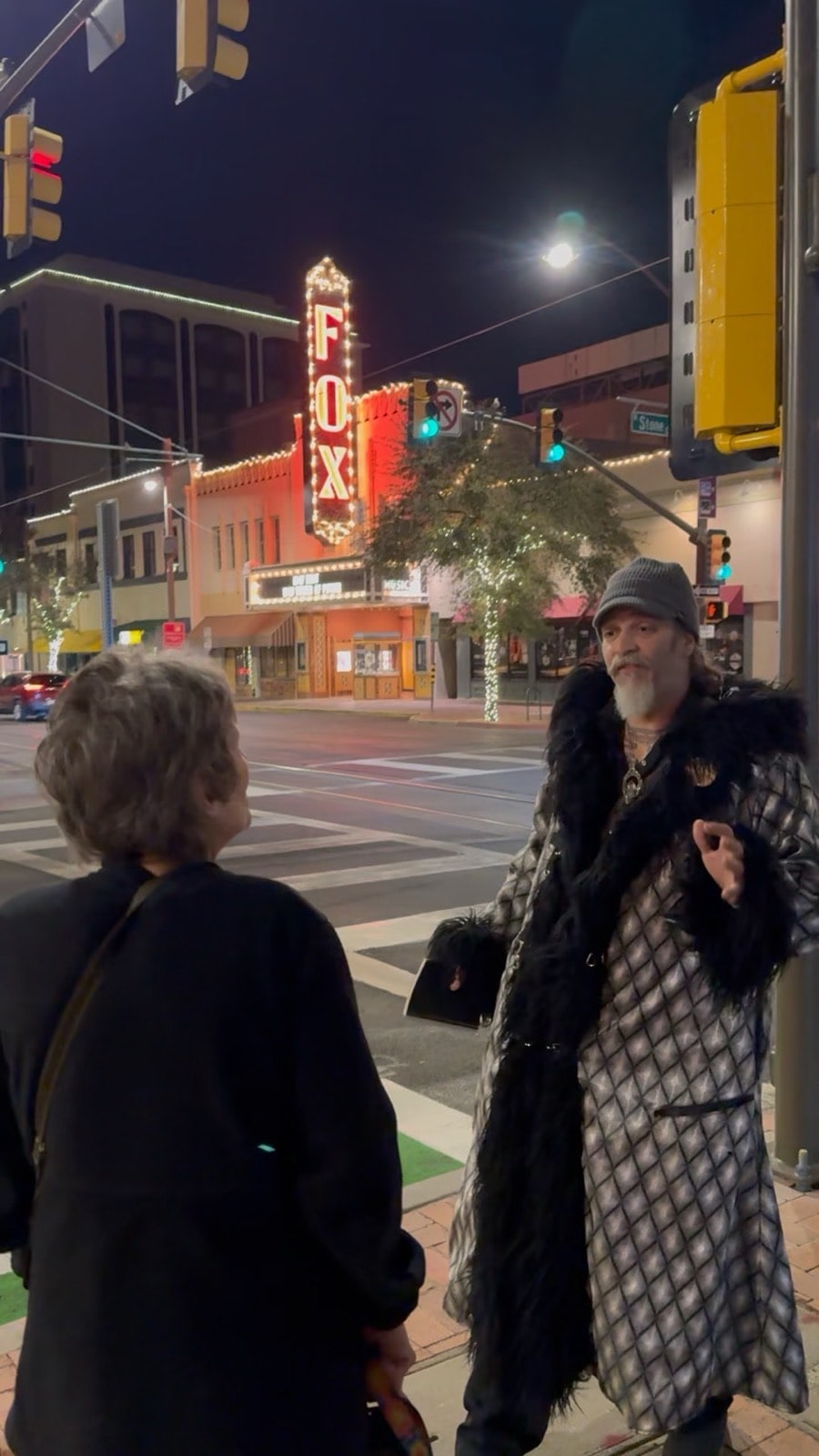 A costumed Freaky Foot Tours guide beneath the Fox Theatre neon