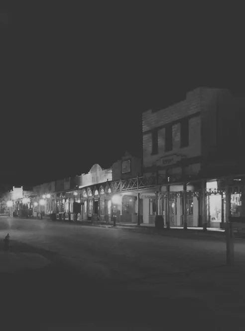 Allen Street in Tombstone at night under the boardwalk lamps
