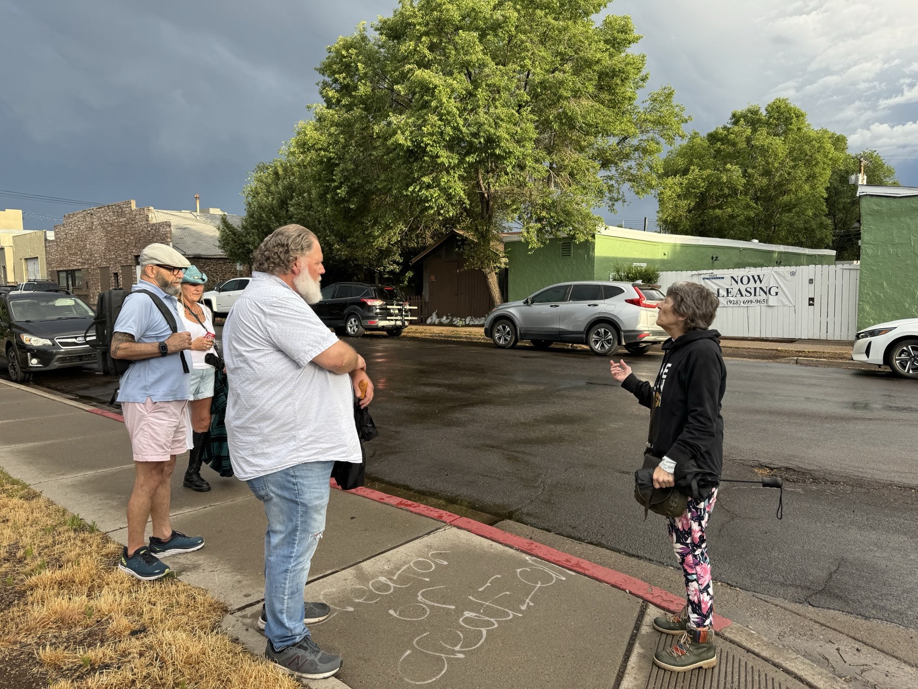 A Freaky Foot Tours guide talking with guests on a Southside Flagstaff street